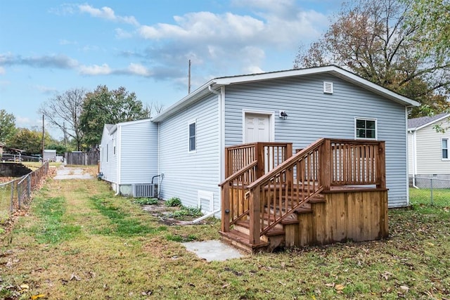 back of house featuring a yard and a wooden deck