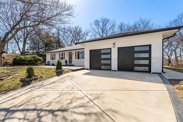 view of front of property featuring a garage and concrete driveway