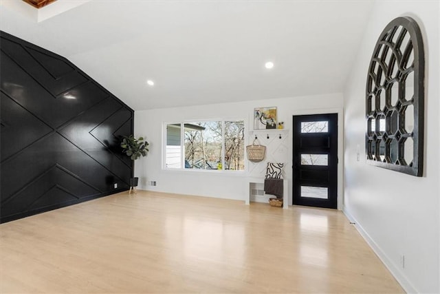 entrance foyer with vaulted ceiling, plenty of natural light, wood finished floors, and recessed lighting