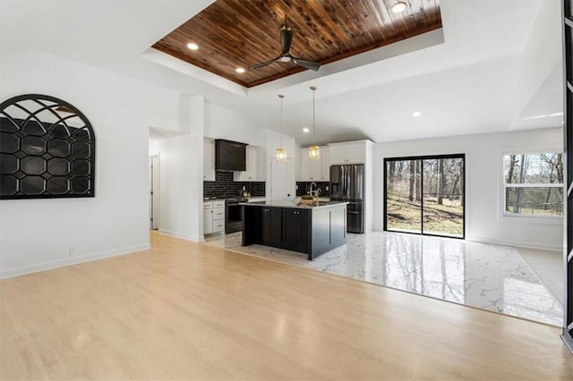 kitchen with a raised ceiling, stainless steel fridge with ice dispenser, open floor plan, and wooden ceiling