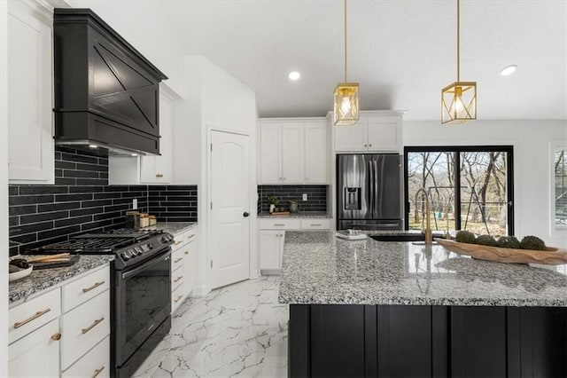 kitchen with black gas range, white cabinets, stainless steel fridge, marble finish floor, and a sink