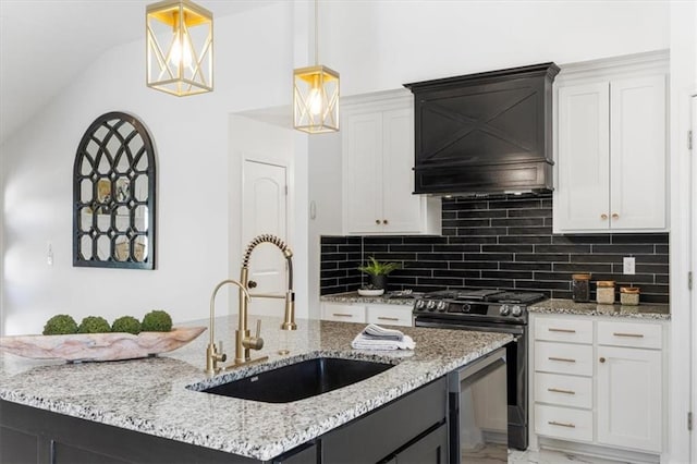 kitchen featuring custom exhaust hood, a sink, decorative backsplash, gas range oven, and decorative light fixtures