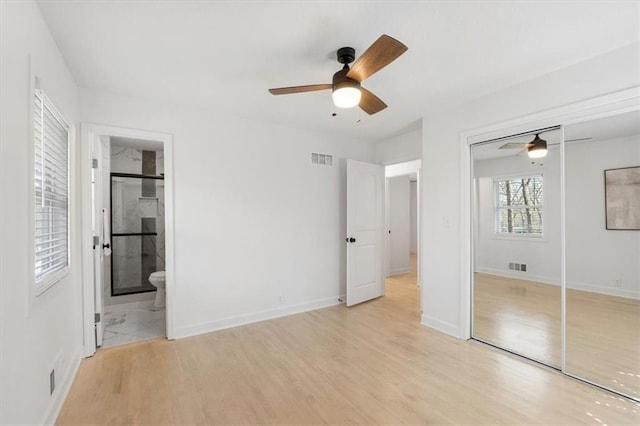 unfurnished bedroom with ceiling fan, light wood-style floors, visible vents, and baseboards