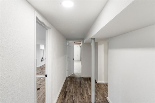 hall featuring wood finished floors and baseboards