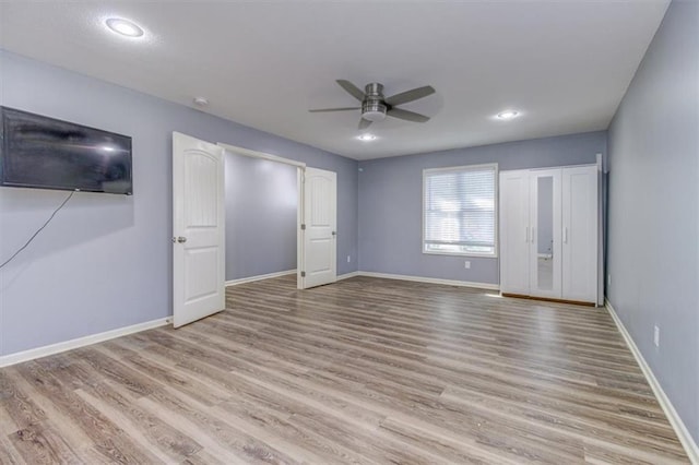 unfurnished bedroom with light hardwood / wood-style floors and ceiling fan