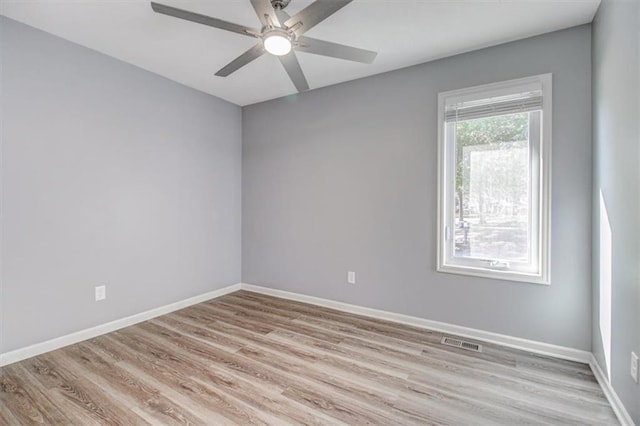 spare room with light hardwood / wood-style floors and ceiling fan