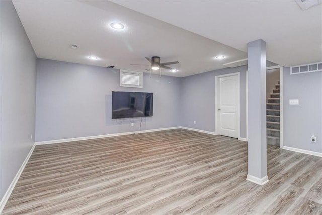 basement with ceiling fan and light hardwood / wood-style flooring