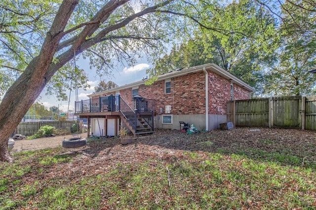 rear view of property with a wooden deck