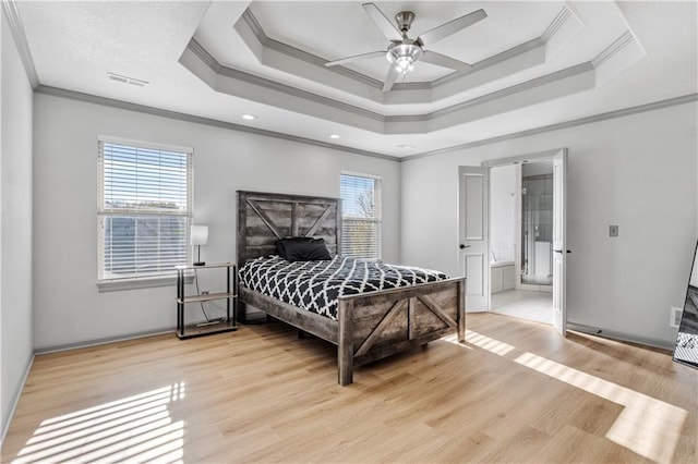 bedroom featuring light wood-type flooring, multiple windows, and crown molding