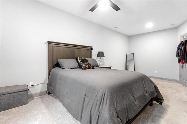 bedroom with light carpet and ceiling fan