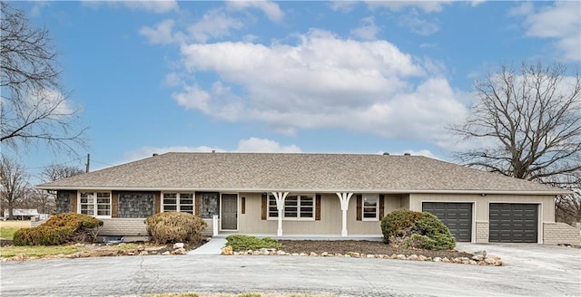 15700 E 202nd St, Peculiar, MO 64078 - single story home featuring a garage, a porch, driveway, and roof with shingles