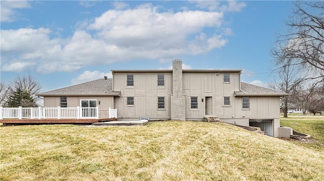 back of property featuring a lawn and a deck