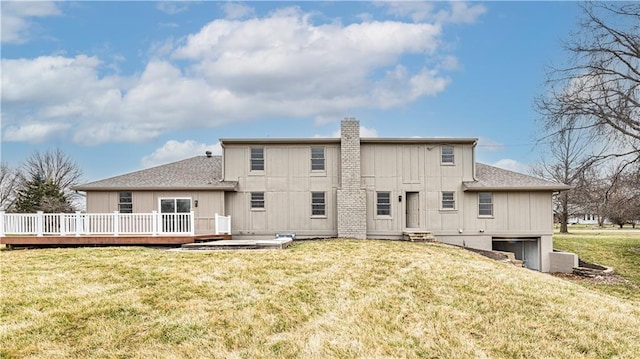 15700 E 202nd St, Peculiar, MO 64078 - rear view of house with an attached garage, a chimney, a deck, and a lawn