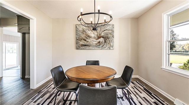 15700 E 202nd St, Peculiar, MO 64078 - dining space featuring a chandelier, dark wood-style flooring, healthy amount of natural light, and baseboards