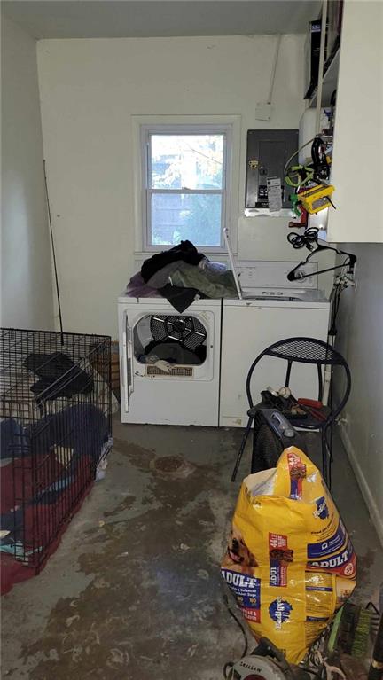 washroom featuring electric panel and washing machine and clothes dryer