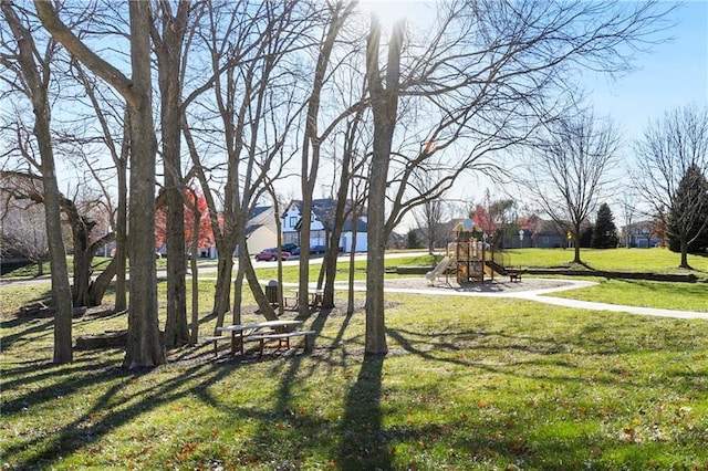 surrounding community featuring a lawn and playground community