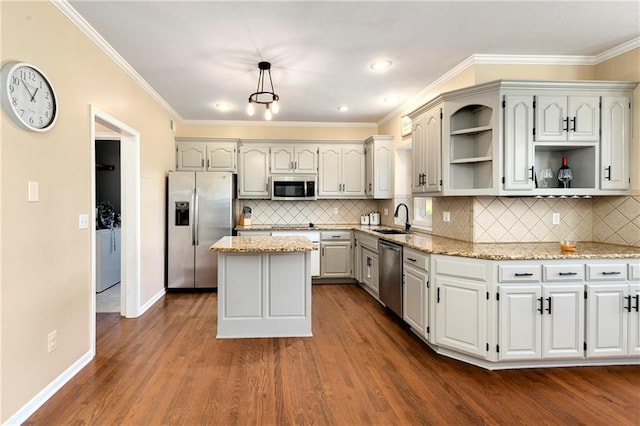 kitchen with pendant lighting, open shelves, stainless steel appliances, a kitchen island, and a sink