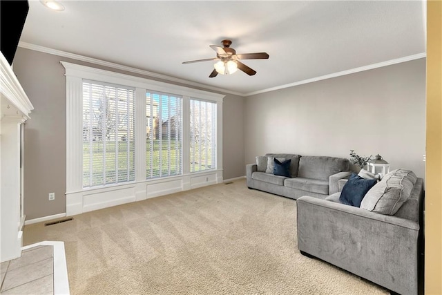 living room featuring ornamental molding, light carpet, visible vents, and baseboards