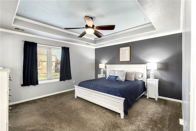 bedroom featuring visible vents, a tray ceiling, and baseboards