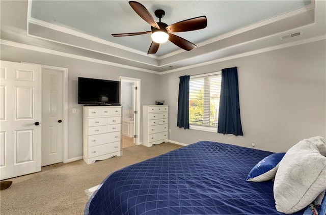 carpeted bedroom with baseboards, visible vents, a raised ceiling, and ornamental molding