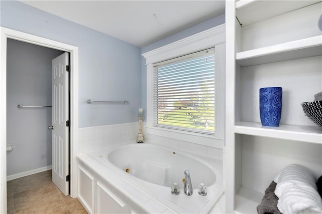 full bathroom featuring a tub with jets and tile patterned flooring