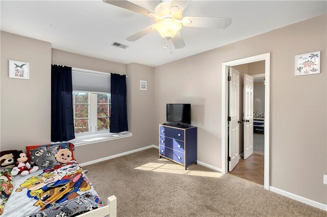 bedroom featuring a ceiling fan, carpet flooring, visible vents, and baseboards