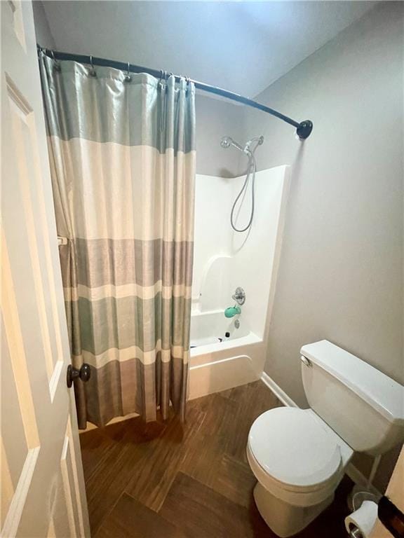 bathroom with shower / bath combination with curtain, toilet, and wood finished floors