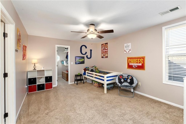 bedroom featuring baseboards, a spacious closet, visible vents, and carpet flooring