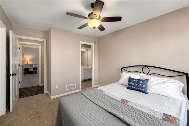 bedroom with light carpet, baseboards, visible vents, a ceiling fan, and ensuite bathroom