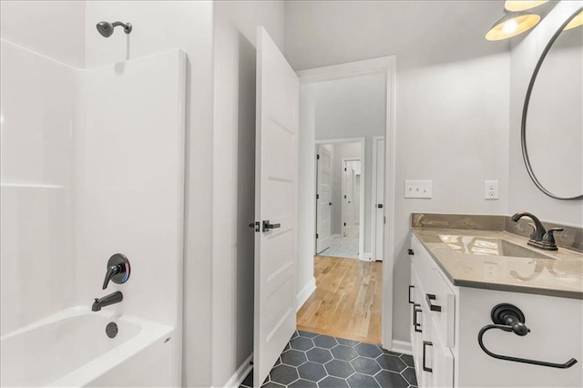 bathroom featuring vanity, hardwood / wood-style floors, and bathtub / shower combination