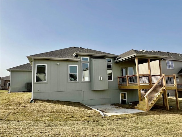 rear view of property featuring central air condition unit, a shingled roof, stairs, and a deck