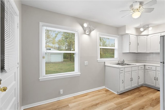 kitchen featuring white cabinetry, light hardwood / wood-style floors, and sink