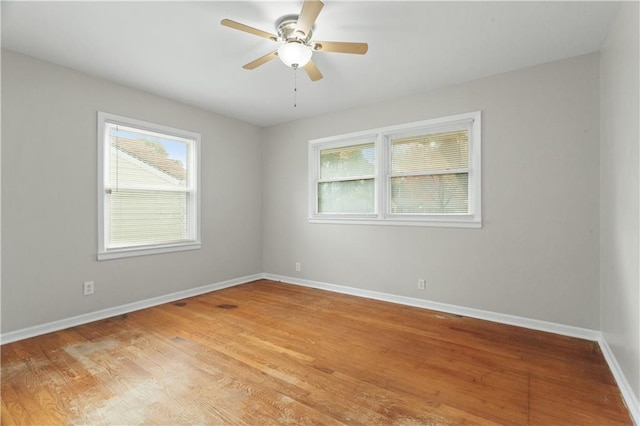 spare room featuring light hardwood / wood-style flooring and ceiling fan