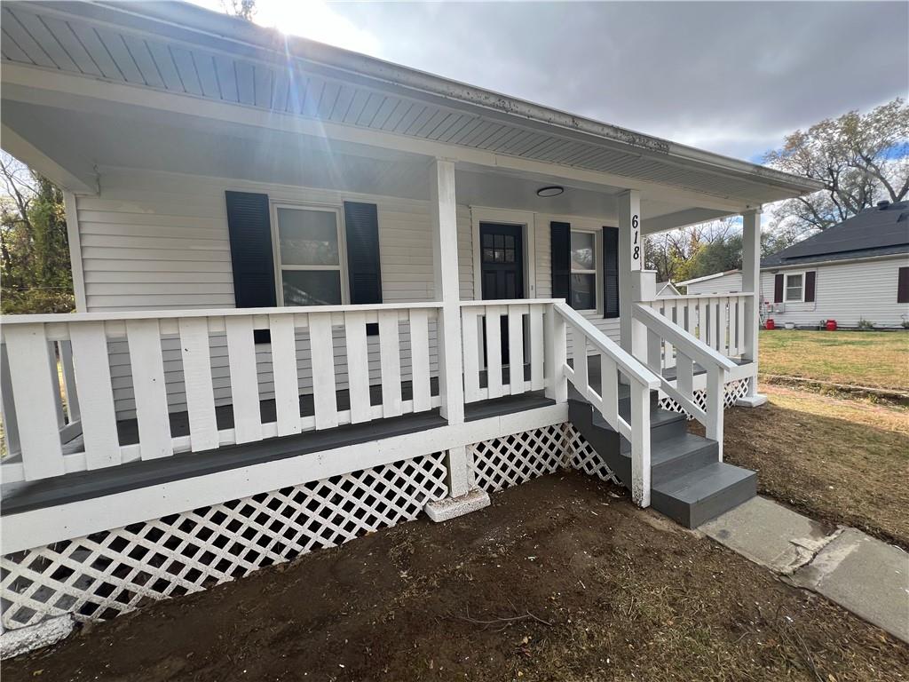 view of exterior entry with covered porch