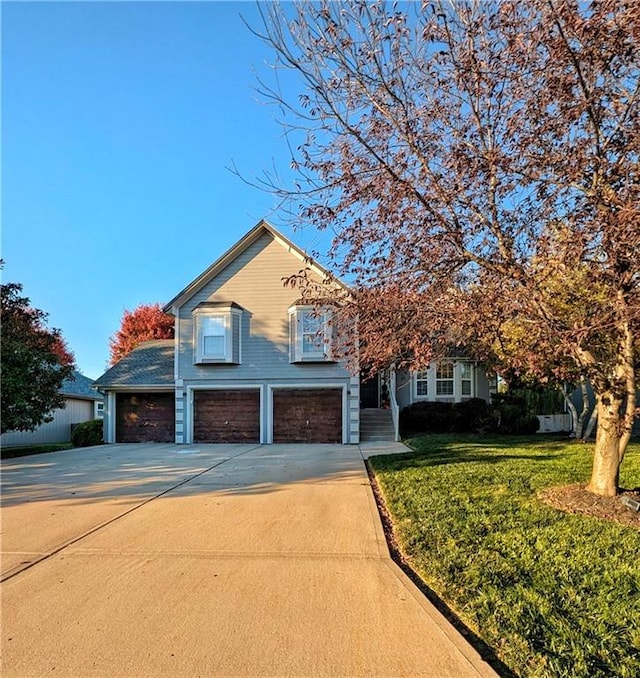 view of front of property with a garage and a front yard