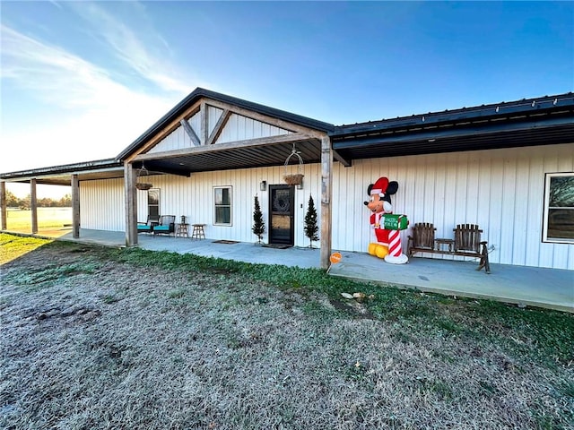 back of house featuring a lawn and a patio