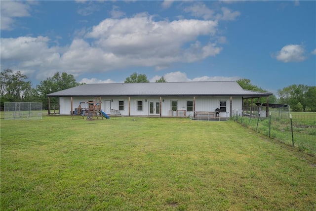 5528 Lostine Rd, Galena, KS 66739 - rear view of property featuring french doors, metal roof, fence, a playground, and a yard