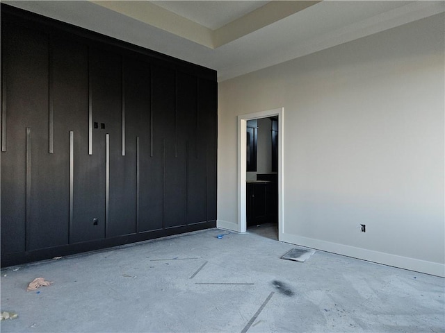 unfurnished bedroom featuring a raised ceiling