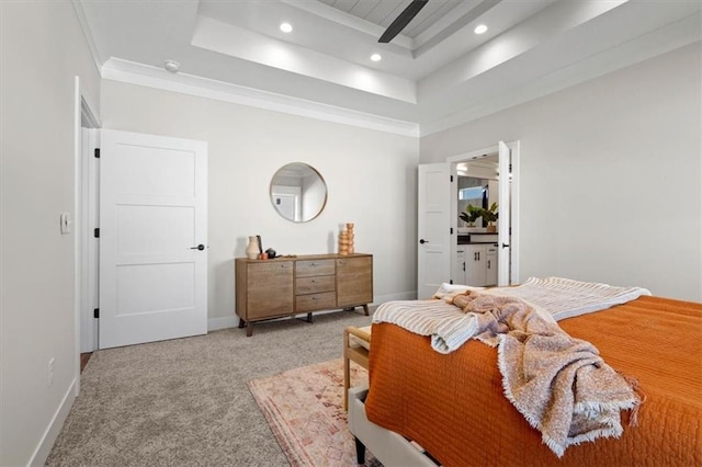 carpeted bedroom with crown molding and a raised ceiling