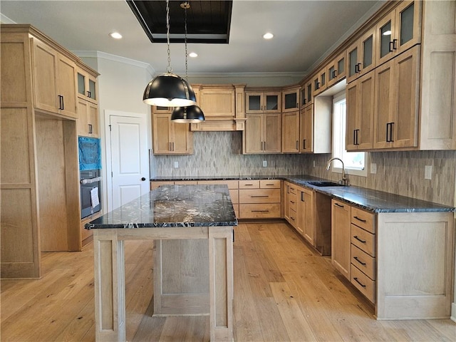 kitchen with pendant lighting, sink, decorative backsplash, a center island, and black appliances