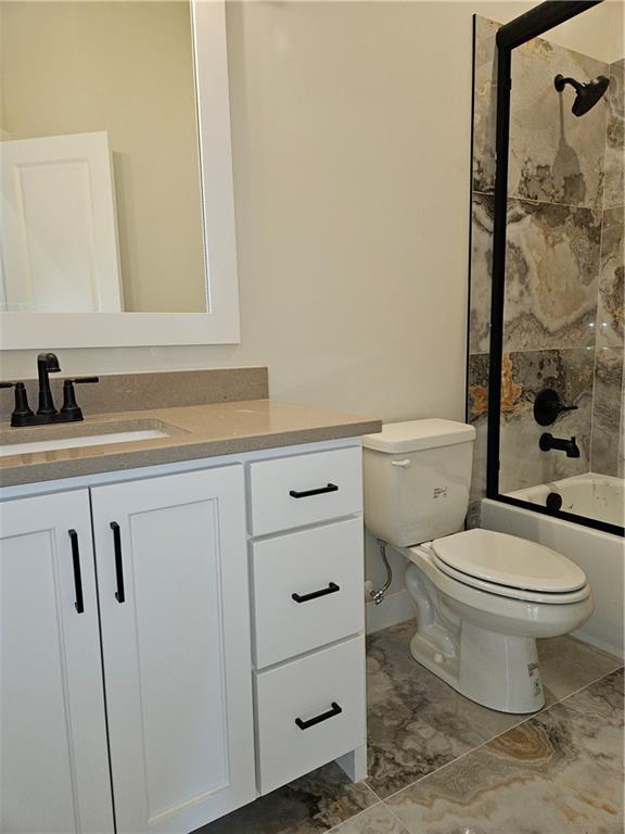 full bathroom with toilet, vanity, and bath / shower combo with glass door