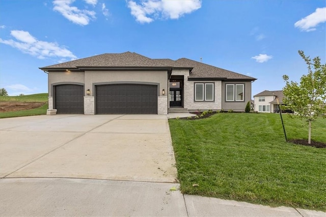 4287 Lake Shore Ct, Basehor, KS 66007 - prairie-style house featuring an attached garage, driveway, stucco siding, and a front yard