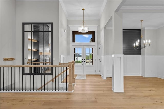 4287 Lake Shore Ct, Basehor, KS 66007 - entrance foyer with ornamental molding, wood finished floors, a decorative wall, a chandelier, and french doors