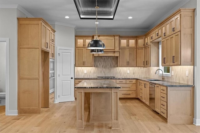 4287 Lake Shore Ct, Basehor, KS 66007 - kitchen featuring appliances with stainless steel finishes, a sink, dark stone counters, light wood-type flooring, and a kitchen island