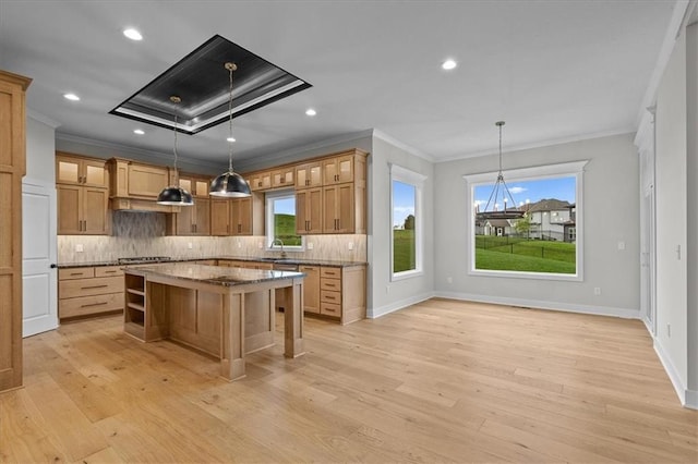 4287 Lake Shore Ct, Basehor, KS 66007 - kitchen with crown molding, a kitchen breakfast bar, a center island, tasteful backsplash, and light wood-style flooring