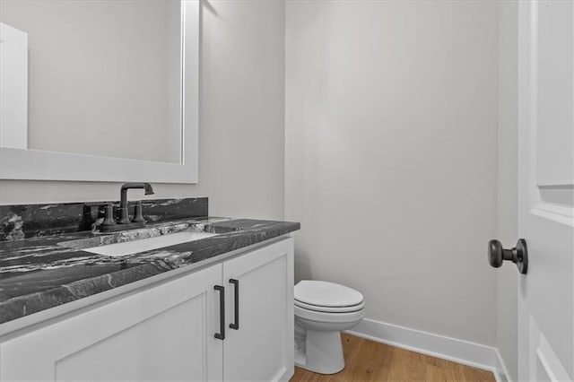 4287 Lake Shore Ct, Basehor, KS 66007 - bathroom featuring vanity, baseboards, wood finished floors, and toilet