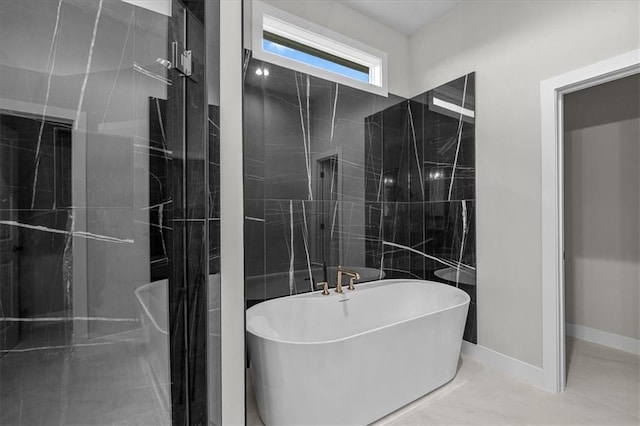 4287 Lake Shore Ct, Basehor, KS 66007 - bathroom with baseboards and a freestanding bath