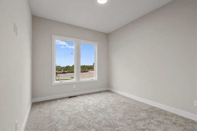 4287 Lake Shore Ct, Basehor, KS 66007 - spare room featuring baseboards, carpet, and visible vents
