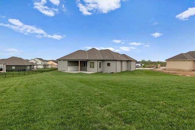 4287 Lake Shore Ct, Basehor, KS 66007 - rear view of house featuring a lawn, fence, and a patio area