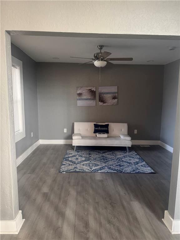 unfurnished living room featuring ceiling fan and hardwood / wood-style flooring